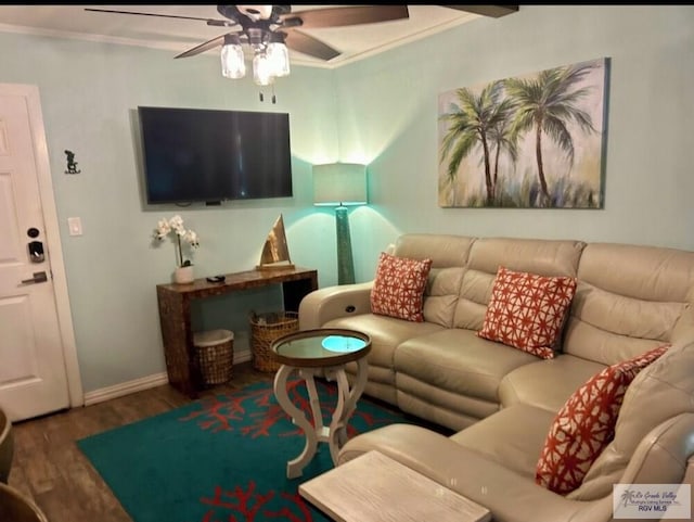 living area with ceiling fan, crown molding, baseboards, and wood finished floors