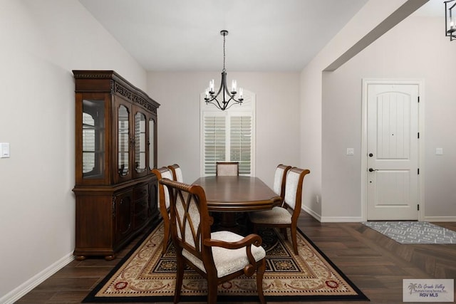 dining space featuring a chandelier and dark hardwood / wood-style floors