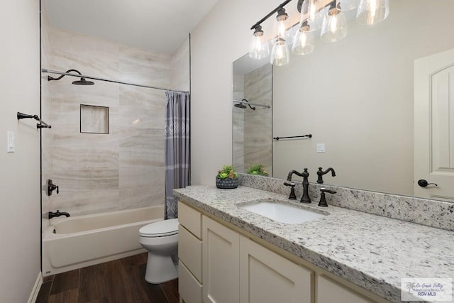 full bathroom featuring hardwood / wood-style floors, vanity, toilet, and shower / bath combination with curtain