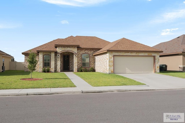 view of front of property with a front yard and a garage