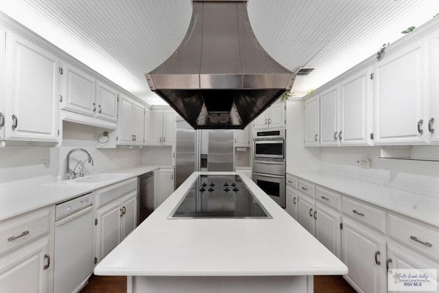 kitchen featuring a kitchen island, appliances with stainless steel finishes, island range hood, sink, and white cabinets