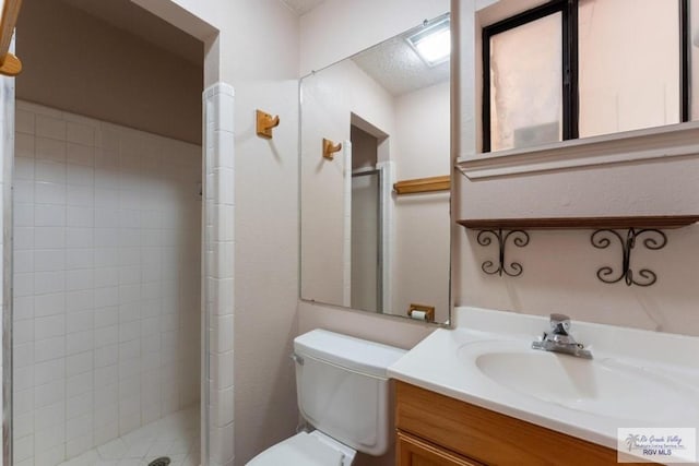 bathroom featuring vanity, an enclosed shower, and toilet