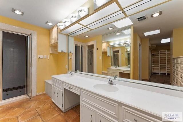 bathroom with vanity and a shower with shower door