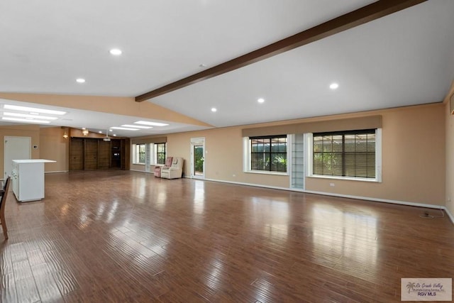 unfurnished living room with dark wood-type flooring and lofted ceiling with beams