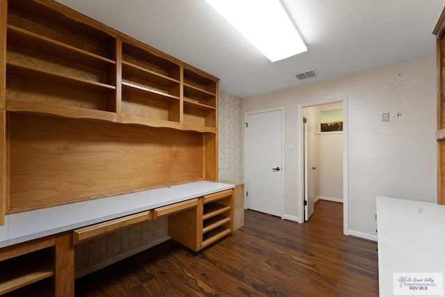 interior space featuring dark hardwood / wood-style flooring and built in desk