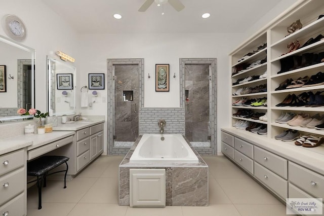 full bath with ceiling fan, a garden tub, vanity, tile patterned floors, and a stall shower