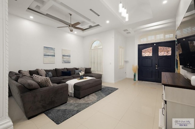 living area featuring ceiling fan, a tray ceiling, visible vents, and recessed lighting