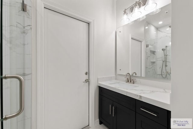 bathroom featuring vanity and a shower with shower door