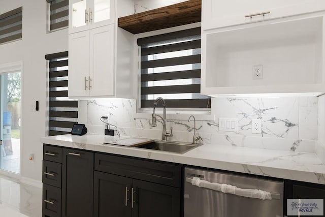 bar with sink, dishwasher, light stone countertops, decorative backsplash, and white cabinets