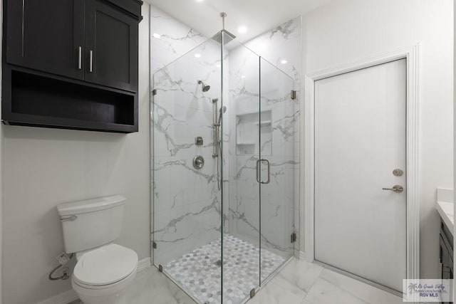 bathroom featuring walk in shower, vanity, and toilet