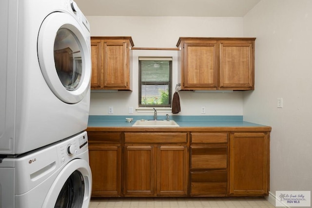 1808 E Palm Valley Dr, Harlingen, TX 78552 - laundry area with stacked washing machine and dryer and cabinet space