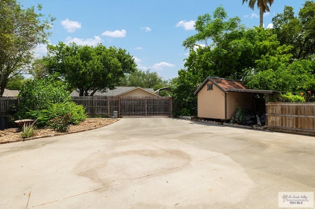 1808 E Palm Valley Dr, Harlingen, TX 78552 - view of patio / terrace featuring fence, a shed, a gate, and an outdoor structure