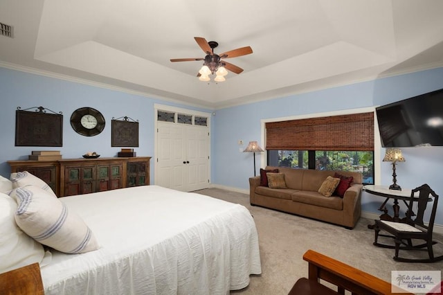 1808 E Palm Valley Dr, Harlingen, TX 78552 - carpeted bedroom featuring a tray ceiling, baseboards, ornamental molding, and a ceiling fan