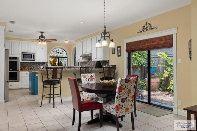 1808 E Palm Valley Dr, Harlingen, TX 78552 - dining room featuring healthy amount of natural light, light tile patterned flooring, ceiling fan, ornamental molding, and baseboards