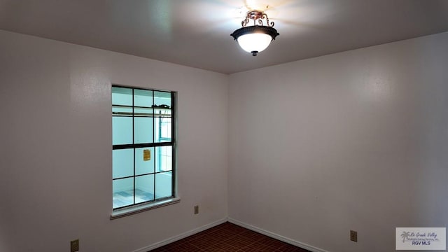 spare room featuring baseboards