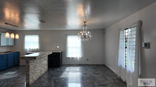 unfurnished dining area featuring marble finish floor, visible vents, a wealth of natural light, and a chandelier