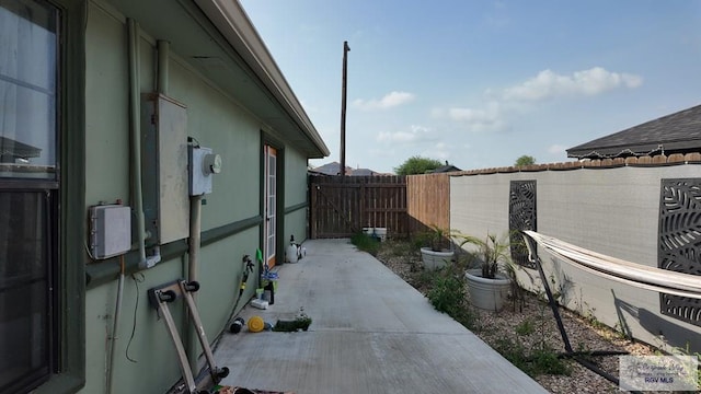 view of home's exterior with fence and a patio area