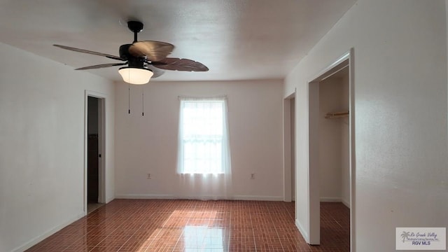 unfurnished bedroom featuring a ceiling fan, a closet, and baseboards