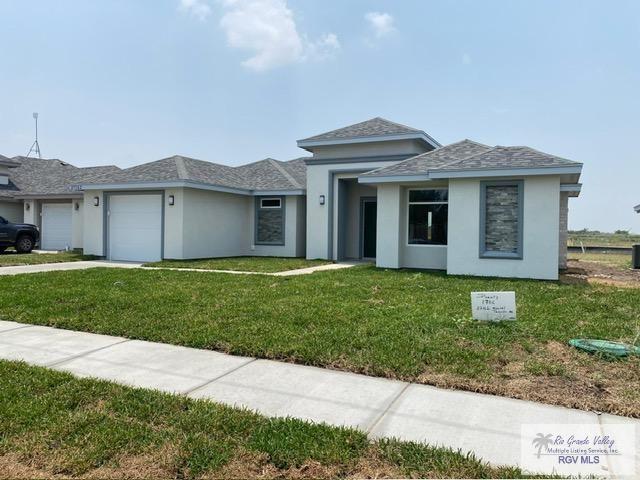 view of front facade featuring a garage and a front lawn