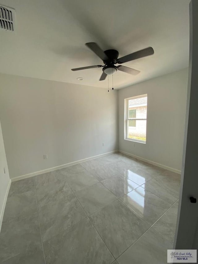 tiled empty room with ceiling fan