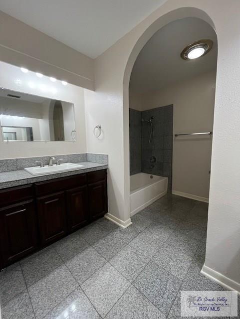 bathroom featuring vanity and tiled shower / bath combo