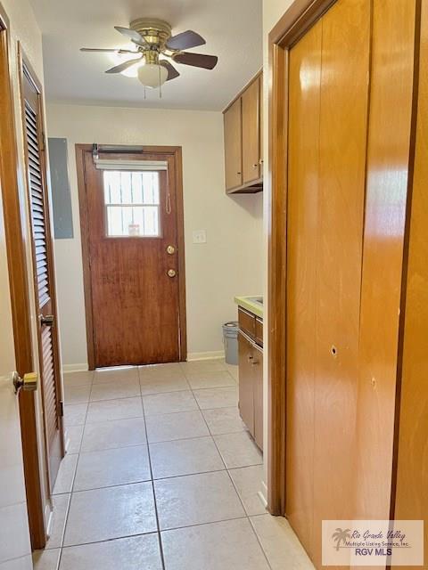 interior space with ceiling fan and light tile patterned floors