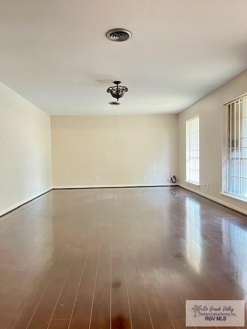 unfurnished room featuring dark hardwood / wood-style flooring