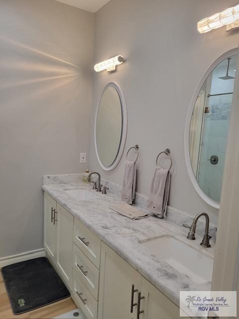 bathroom featuring a shower, vanity, and hardwood / wood-style flooring