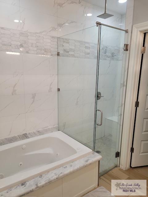 bathroom featuring hardwood / wood-style floors and independent shower and bath