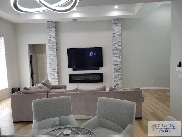 living room featuring a large fireplace and light wood-type flooring