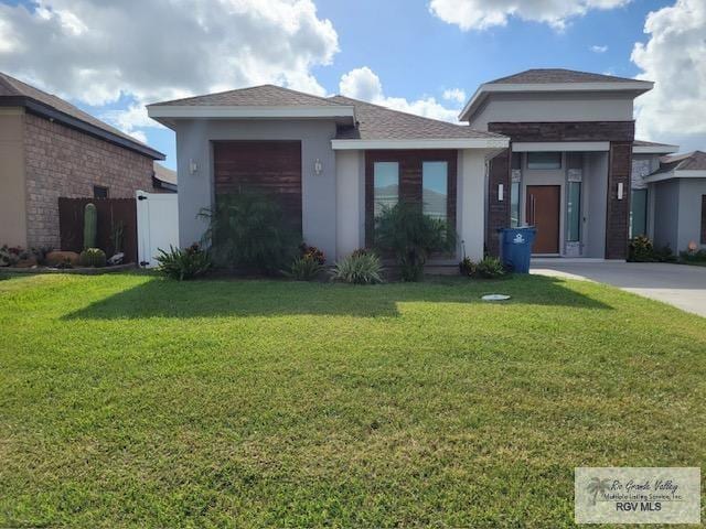 view of front facade with a garage and a front lawn