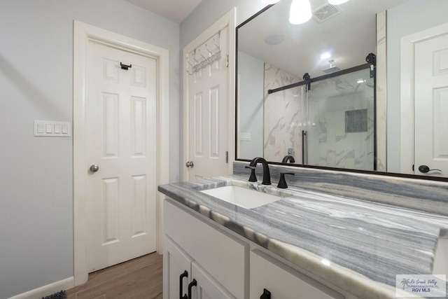 500 Parker Cir # 21, La Feria, TX 78559 - bathroom with a marble finish shower, vanity, and wood finished floors