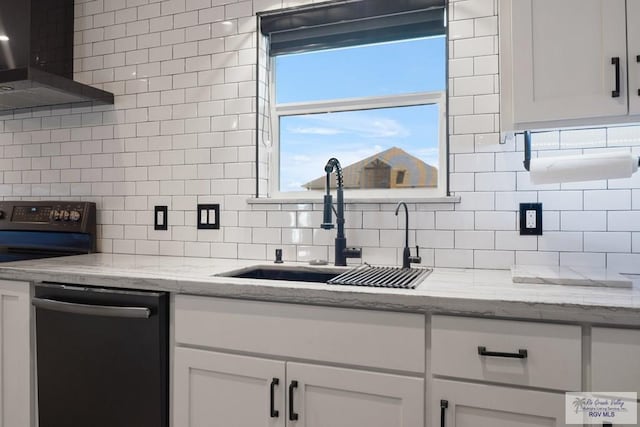 500 Parker Cir # 21, La Feria, TX 78559 - kitchen featuring dishwashing machine, wall chimney exhaust hood, a sink, tasteful backsplash, and white cabinets