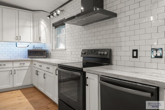500 Parker Cir # 21, La Feria, TX 78559 - kitchen with black range with electric stovetop, dishwashing machine, wall chimney range hood, stainless steel microwave, and decorative backsplash