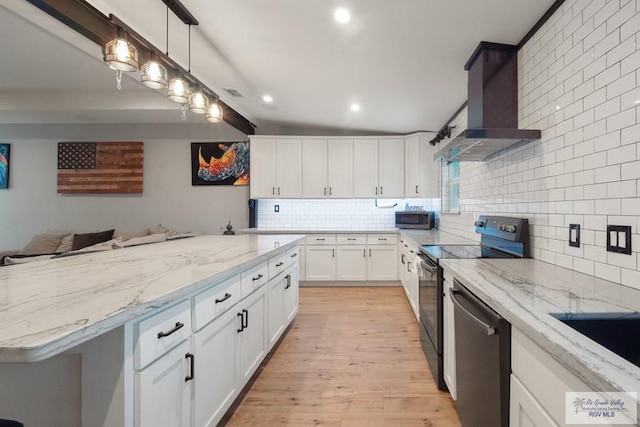 500 Parker Cir # 21, La Feria, TX 78559 - kitchen featuring wall chimney exhaust hood, stainless steel appliances, backsplash, light wood-style floors, and white cabinets