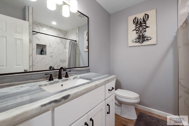 500 Parker Cir # 21, La Feria, TX 78559 - bathroom featuring wood finished floors, toilet, curtained shower, vanity, and baseboards
