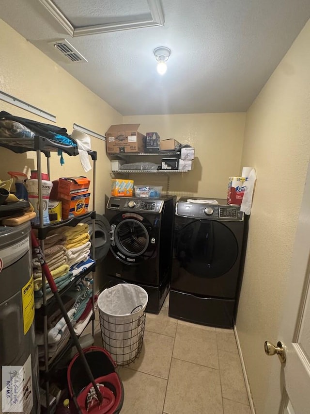 2965 Monte Cristo Dr, Brownsville, TX 78526 - laundry room featuring separate washer and dryer, light tile patterned flooring, electric water heater, and a textured ceiling