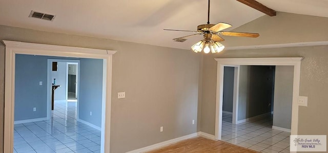 tiled spare room featuring vaulted ceiling with beams and ceiling fan