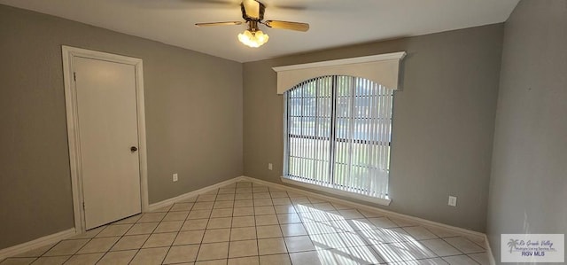 tiled empty room with ceiling fan