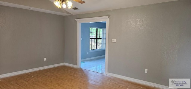 empty room featuring ceiling fan and light hardwood / wood-style floors