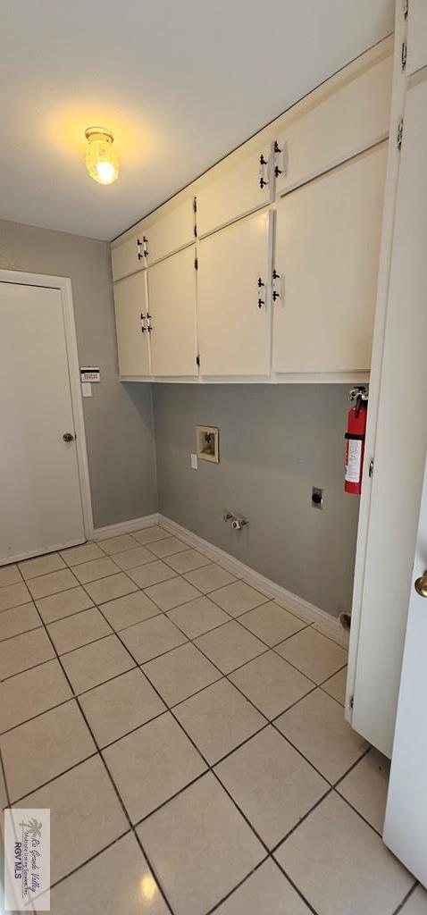 laundry room with hookup for a washing machine, light tile patterned flooring, cabinets, and hookup for an electric dryer