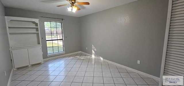 unfurnished room featuring ceiling fan and light tile patterned flooring