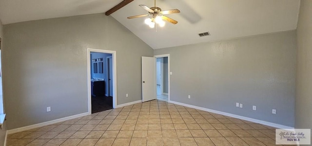 interior space with lofted ceiling with beams, ceiling fan, light tile patterned floors, and ensuite bathroom