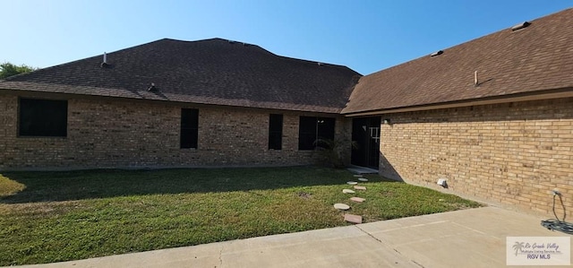 back of property featuring a patio area and a yard