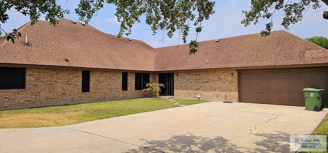 single story home with a garage and a front yard