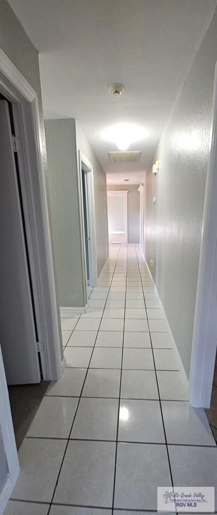 corridor featuring light tile patterned flooring