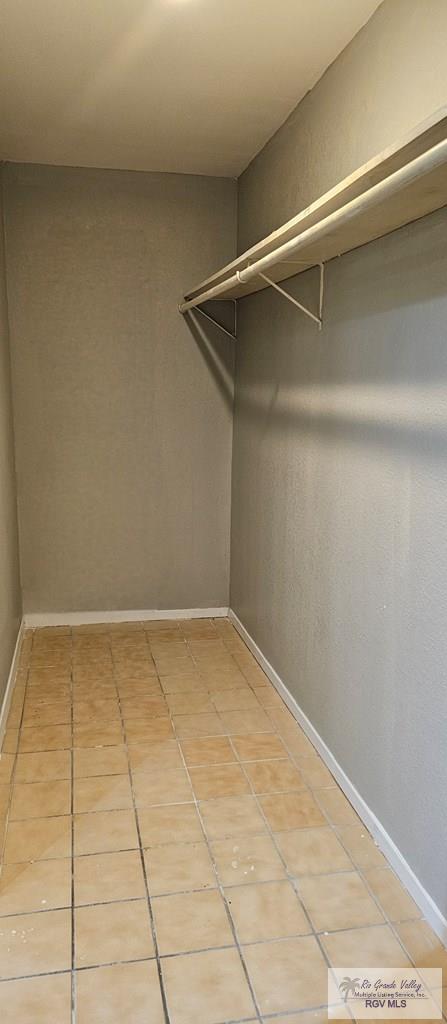 walk in closet featuring light tile patterned flooring