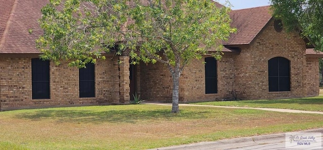 view of property exterior featuring a lawn