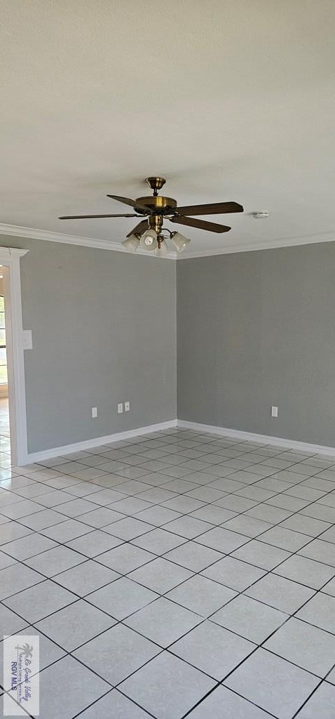 unfurnished room featuring ceiling fan, crown molding, and light tile patterned flooring