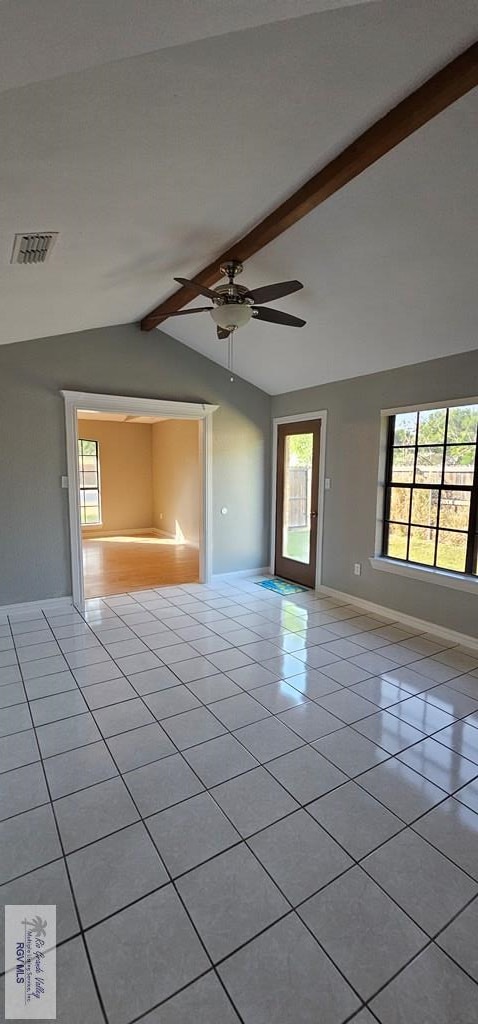 tiled spare room with lofted ceiling with beams and ceiling fan